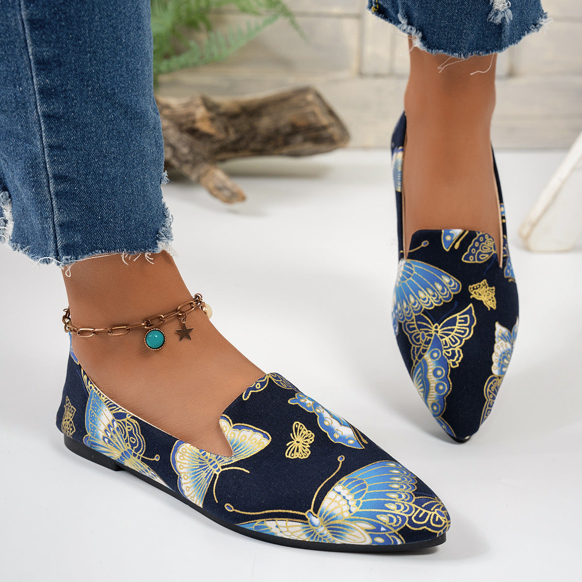 Women’s Flat Pointed-Toe Thin Shoes — Casual Everyday Flats in navy blue with butterfly pattern, paired with casual denim.