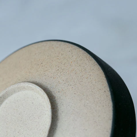 Close-up of Galileo Tableware plate in matte green with golden ring design, handcrafted porcelain, by Home And Tower.