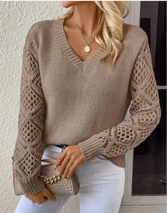 Woman wearing Women's Long Sleeve Hollow Knitted Sweater with V-neck design in a cozy fall style, paired with white pants.