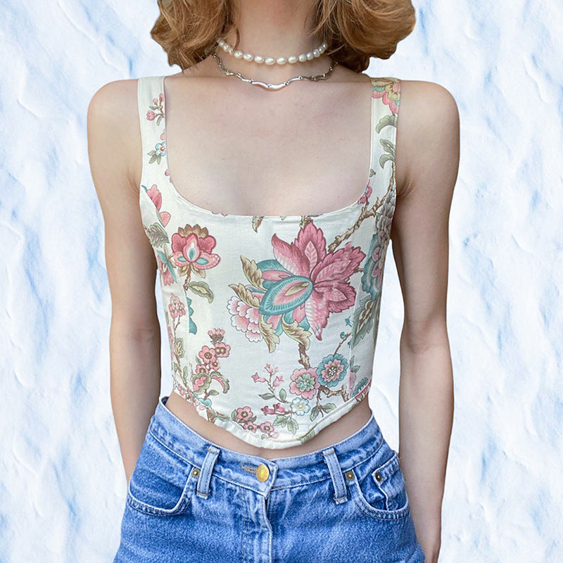 Woman wearing Floral Lace-Up Back Vest Top with pink and blue floral print, square neckline, and lace-up back, styled with jeans.