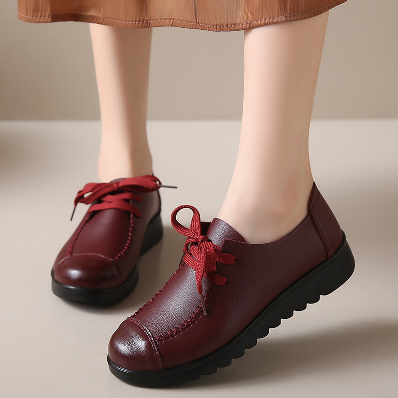Maroon casual lace-up shoes with soft soles for women.