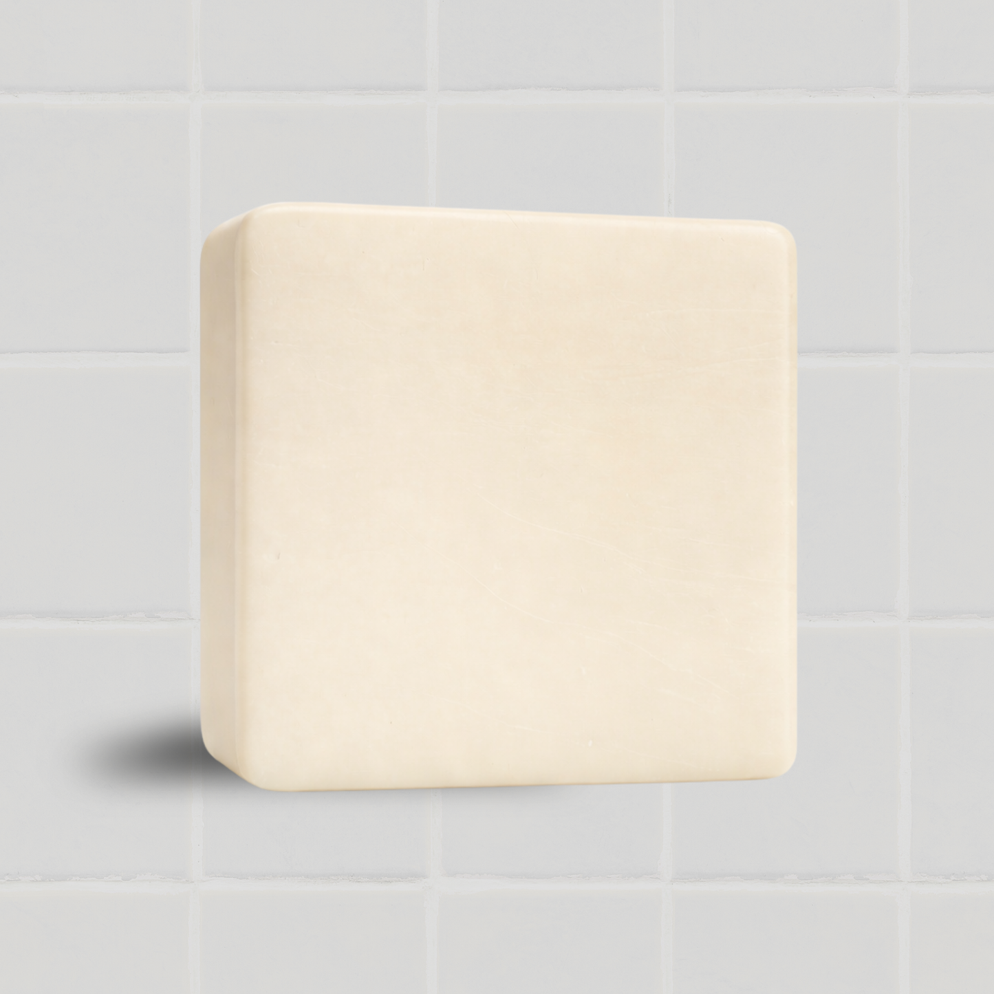 Authentic Bar Soap against a white tiled background, fragrance-free and gentle for daily use, purifies and brightens skin.