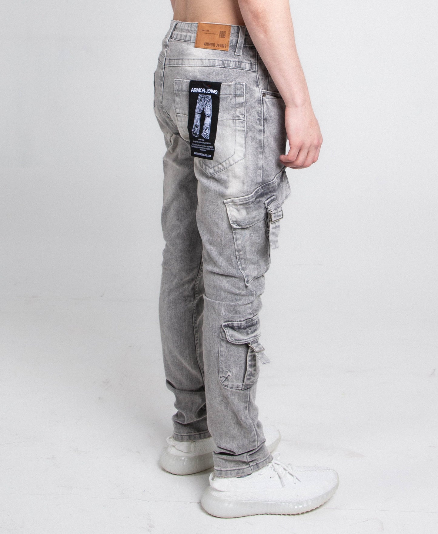 Model wearing A408 CARGO POCKETS GREY SKINNY jeans with a slim ripped design, mid rise waist, and white sneakers.