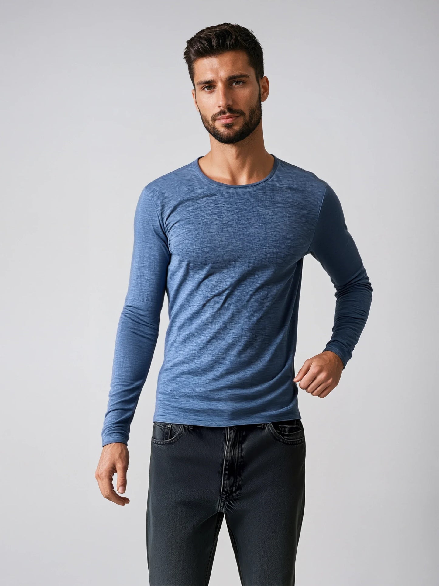Man wearing blue Long Sleeve Rollneck T-Shirt with light fabric and flattering fit.