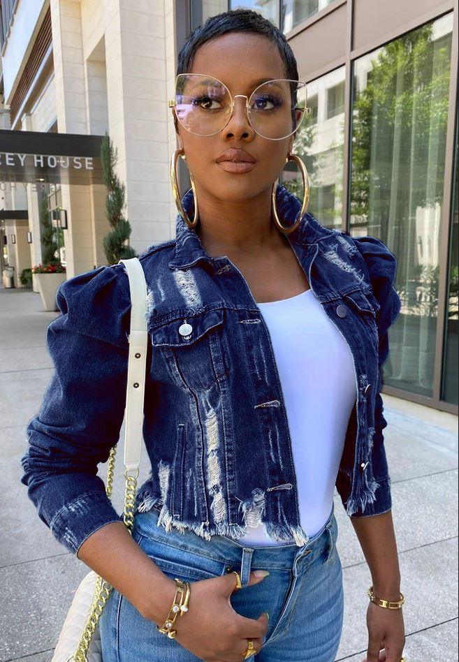 Woman wearing Chic Distressed Denim Puffy Sleeves Jacket – Fashionable Cropped Jean Jacket in urban setting.