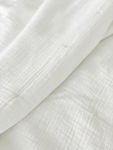 Close-up of Easy Cotton Gauze Quilt & Pillow Set in white, showcasing its lightweight and breathable cotton texture ideal for summer.