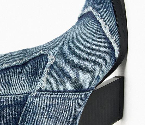 Close-up of the premium distressed denim fabric on Handcrafted Distressed Denim Knee-High Boots, showcasing the rugged design and high heel.