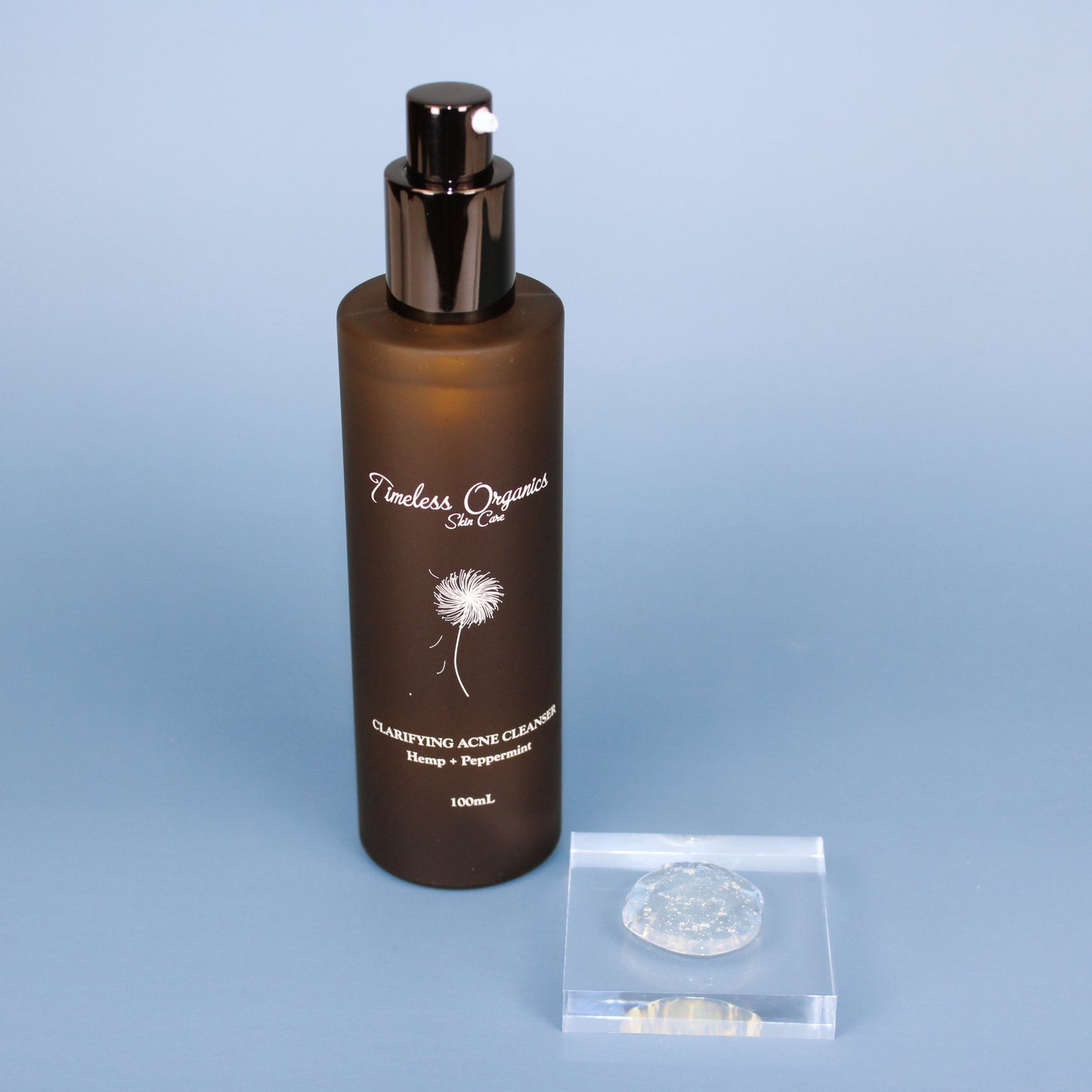 Clarifying Acne Cleanser bottle with brown label on blue background, focusing on soothing and natural skincare for clearer skin.