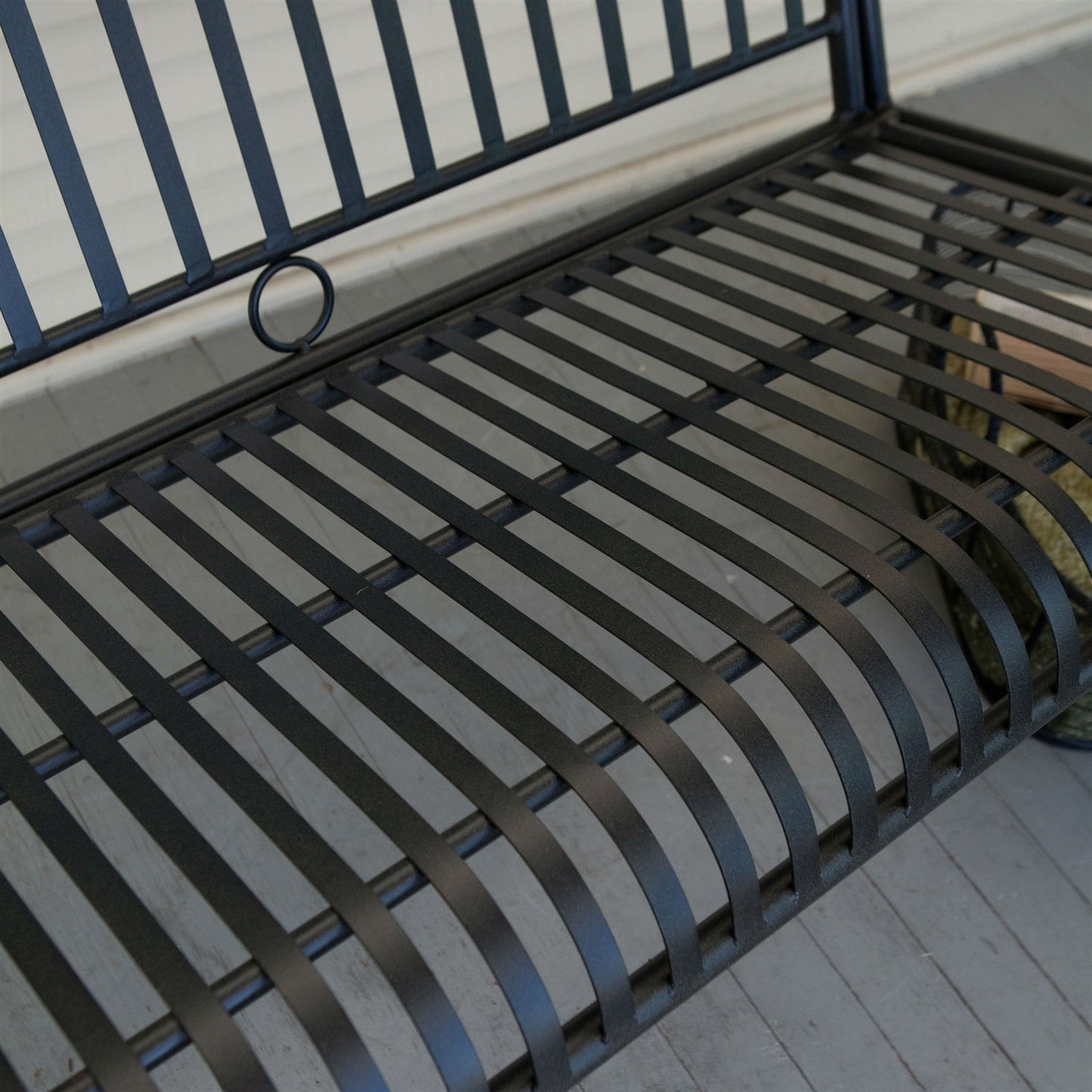 Close-up of Wrought Iron Outdoor Patio 4-Ft Porch Swing in Black with slatted design and powder-coated finish.
