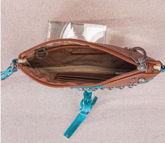 Open view of Tassel Western Clutch & Crossbody Bag showing interior pockets and turquoise stone concho tassels.