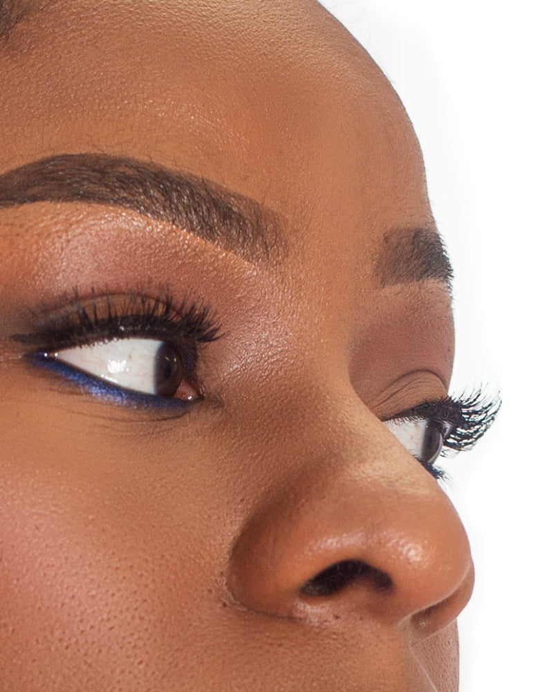 Woman's eye with volumized lashes using LAMIK Beauty's Show Out Mascara, showcasing the product's lightweight lash-extending effect.