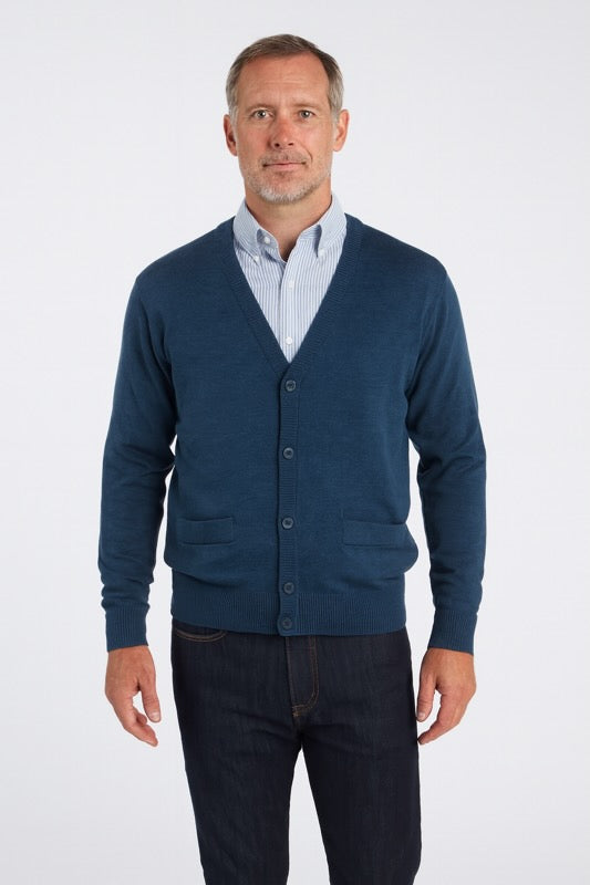 Man wearing Merino Wool Cardigan in Denim with button front and pockets, ideal for layering.