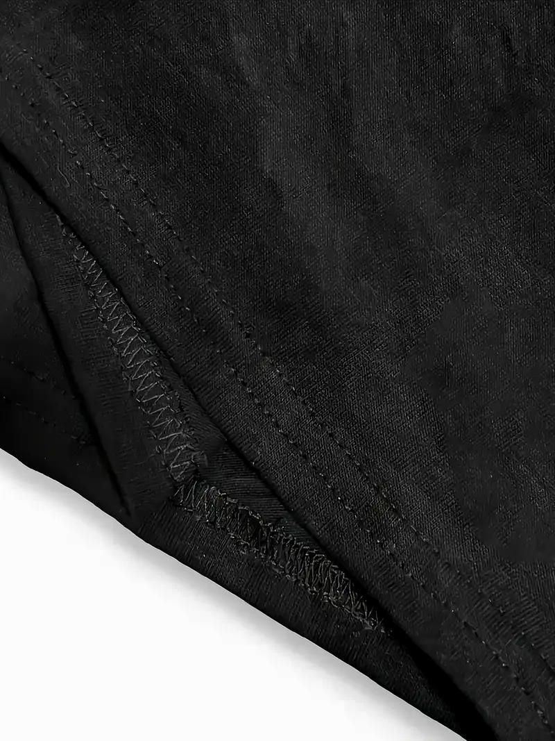 Close-up of double-needle stitched hem on black cotton T-shirt, showing quality craftsmanship.
