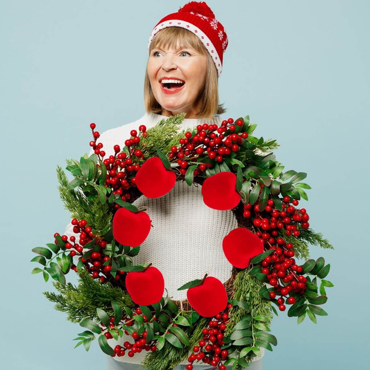 Woman holding festive wreath with 12Pcs Mini Christmas Apple Ornament Fun