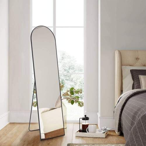Floor Standing Mirror with stand and aluminum alloy thin frame, 21''x64'', full-length body mirror in modern bedroom setting.