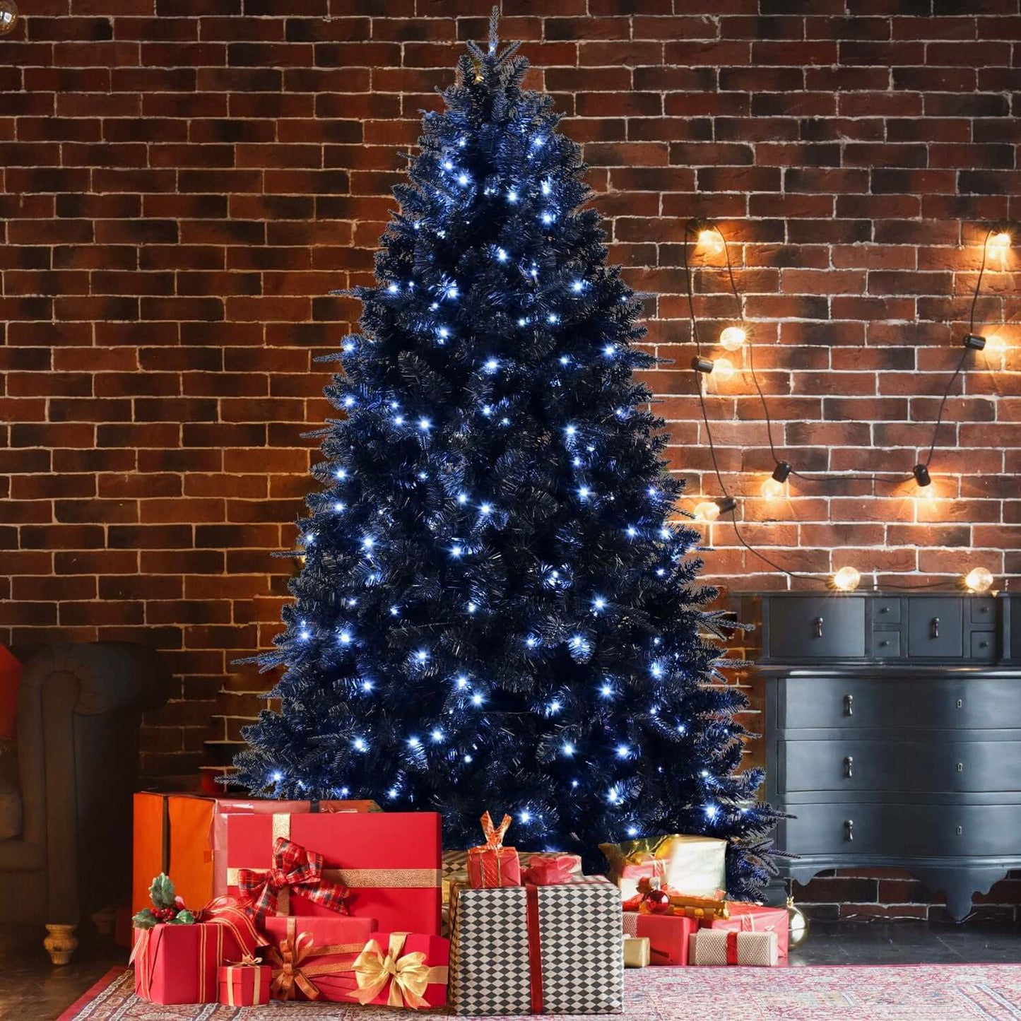 Black Christmas Tree with White LED Lights, 5ft holiday decor against a brick wall background, surrounded by wrapped gifts