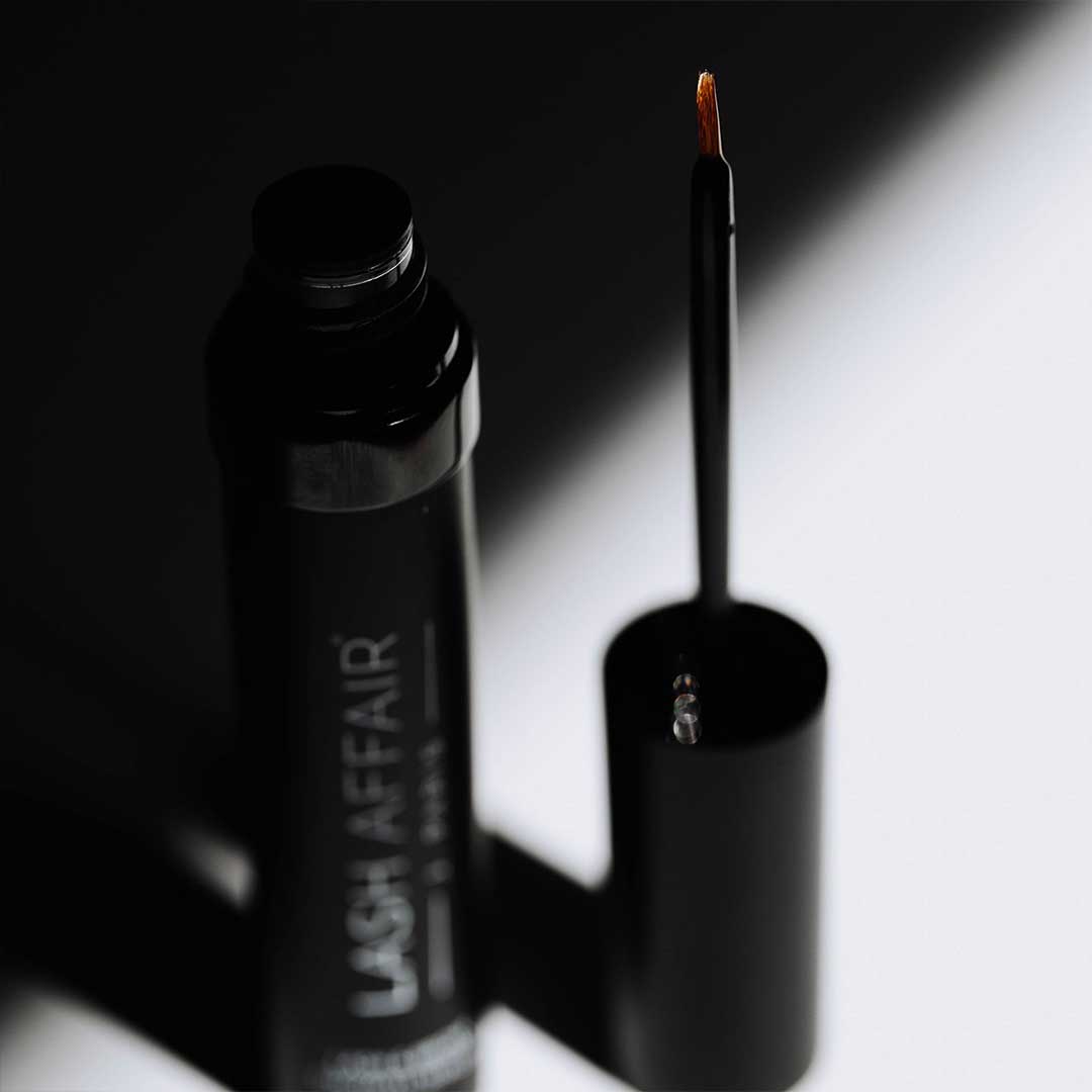 Lashgasm | Lash + Brow Serum with applicator brush, featuring vitamin-rich formula for healthy lashes and brows.