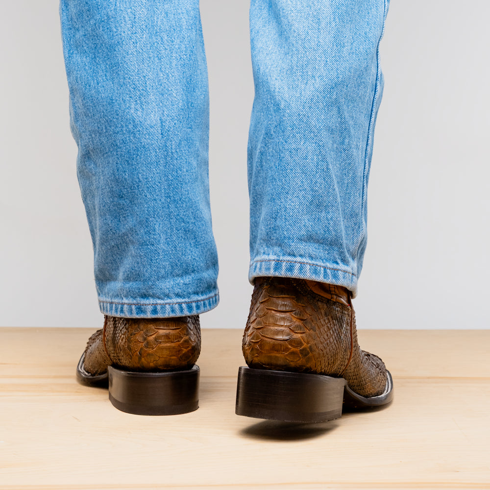 Back view of Missouri Cognac cowboy boots in genuine Python skin with denim jeans.