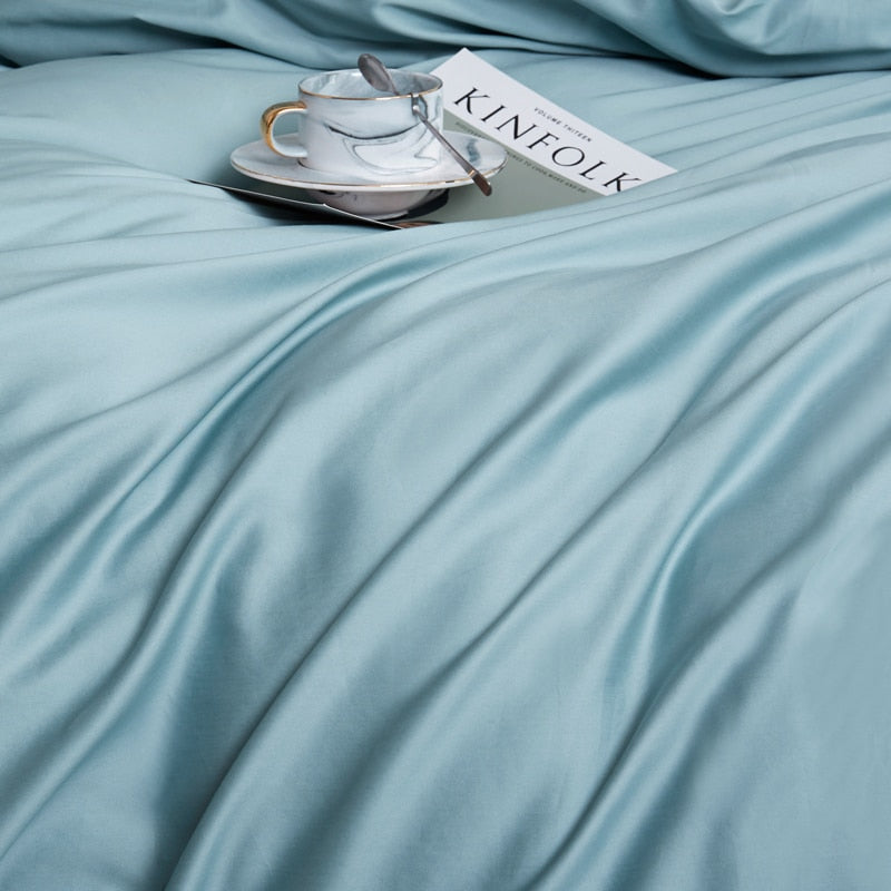 Turquoise Grace Silk Duvet Cover Set (Premium Egyptian Cotton) 600TC displayed with a magazine and coffee cup.