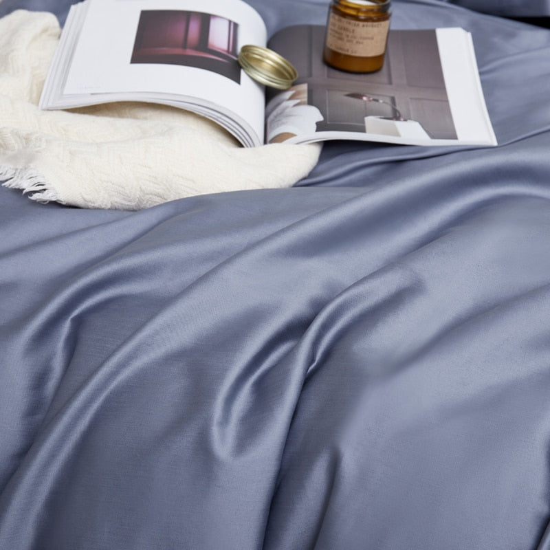 Florentine Grace Silk Duvet Cover Set (Premium Egyptian Cotton) 600TC displayed with book and candle on bed