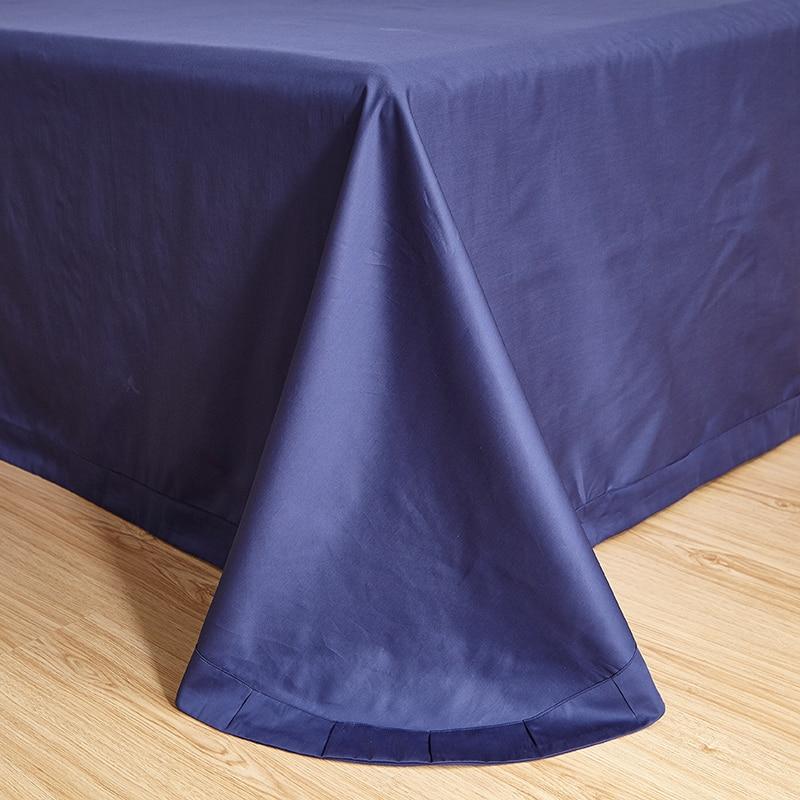 Blue Tail Luxury Duvet Cover Set (60S Egyptian Cotton) in deep blue draped over wooden floor.