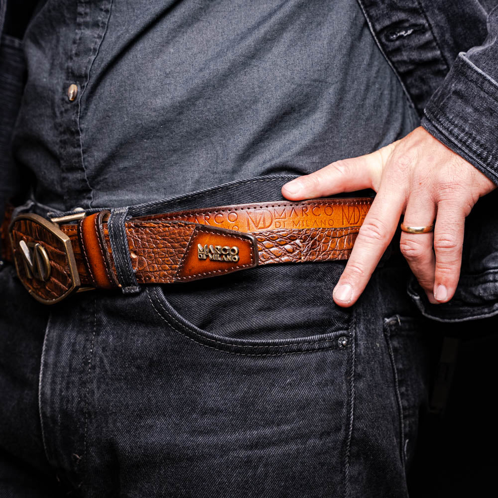 Man wearing Texas Belt Aged Maple with caiman skin and calf leather, featuring Marco Di Milano branding, styled in a casual outfit.