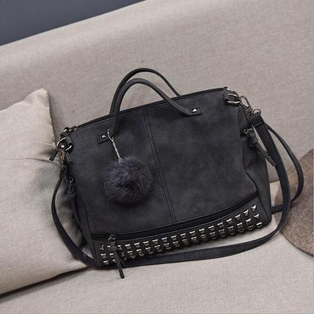 Rustic Charm Leather Shoulder Bag – Stylish Cowgirl Handbag with rivet details and soft, spacious design on a couch.