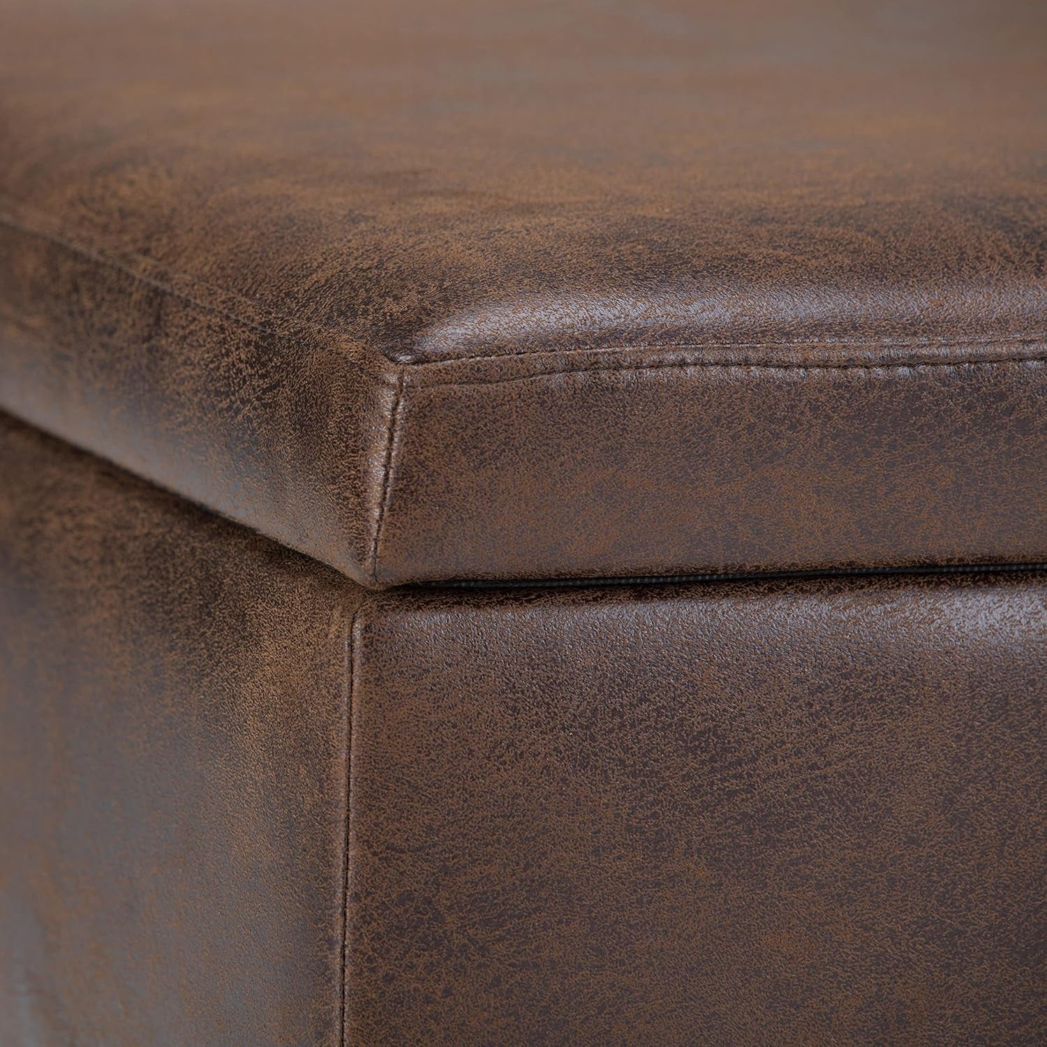 Close-up of vegan leather on Mid Century Distressed Chestnut Lift Top Coffee Table Ottoman with solid wood frame.