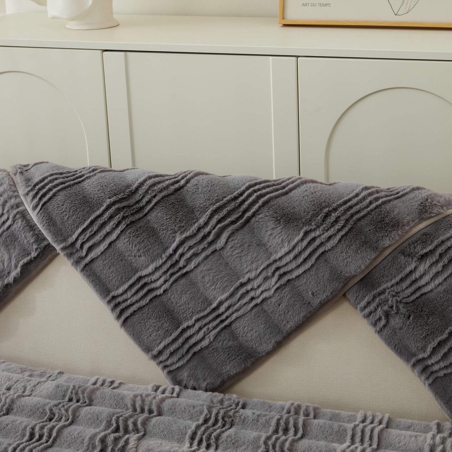 Soft Thick Faux Fur Sofa Cover Stripe Fluffy Fuzzy Non-Slip Washable Couch Covers in gray on a sofa