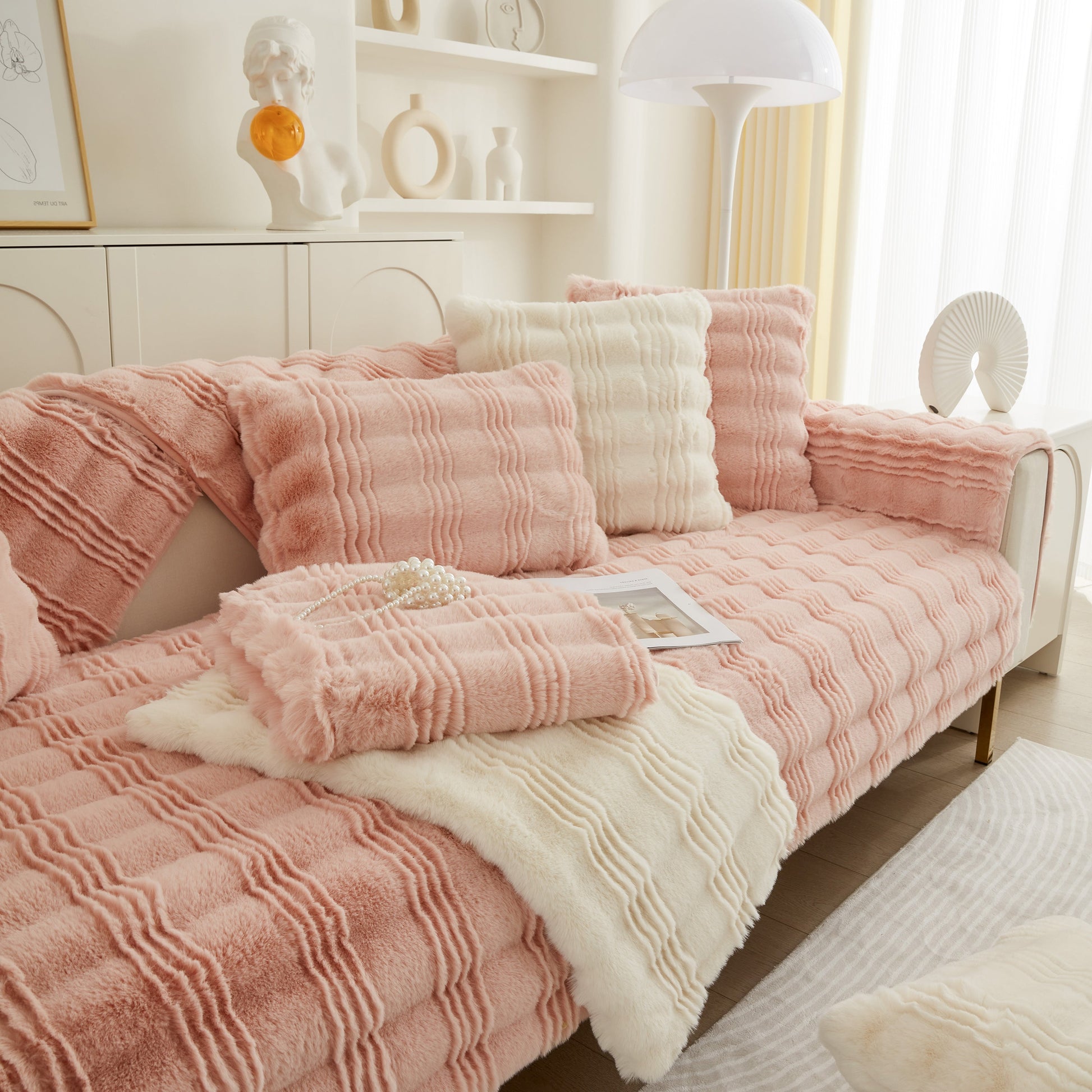 Soft Thick Faux Fur Sofa Cover Stripe Fluffy Fuzzy Non-Slip Washable Couch Covers in pink and cream on a modern sofa.