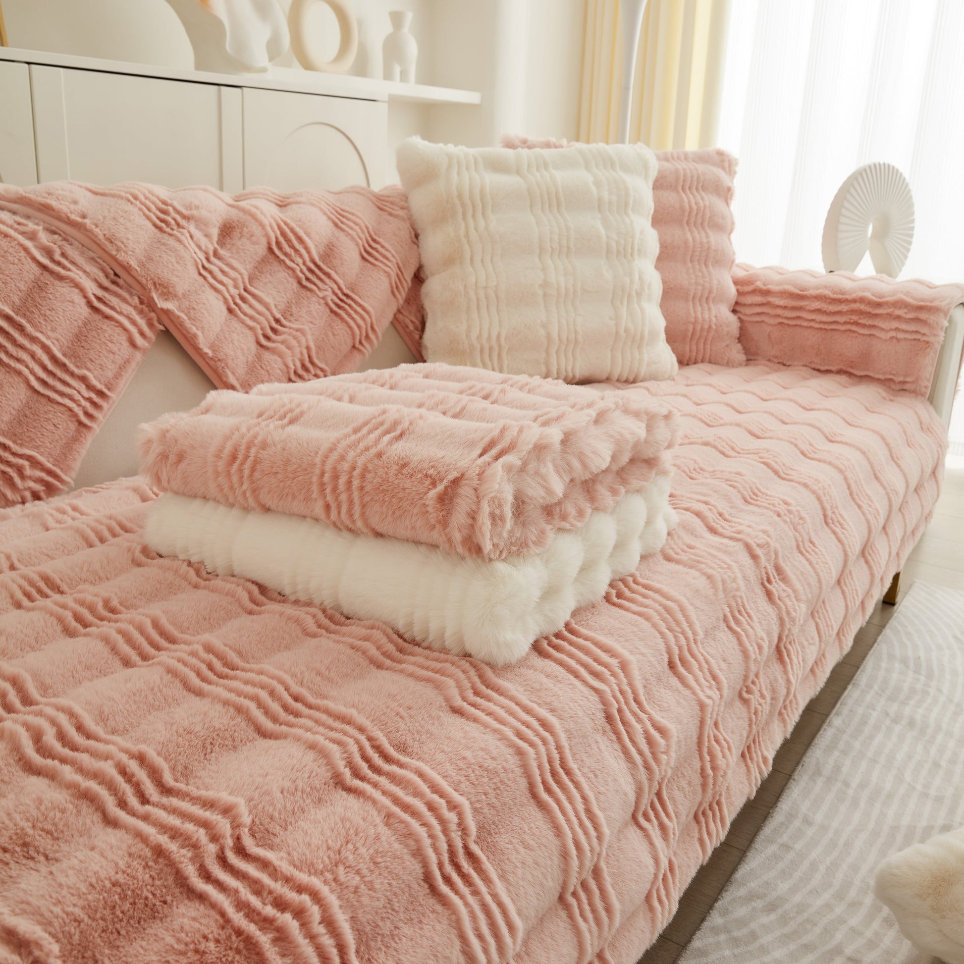 Soft Thick Faux Fur Sofa Cover Stripe Fluffy Fuzzy Non-Slip Washable Couch Covers on a pink couch with matching pillows