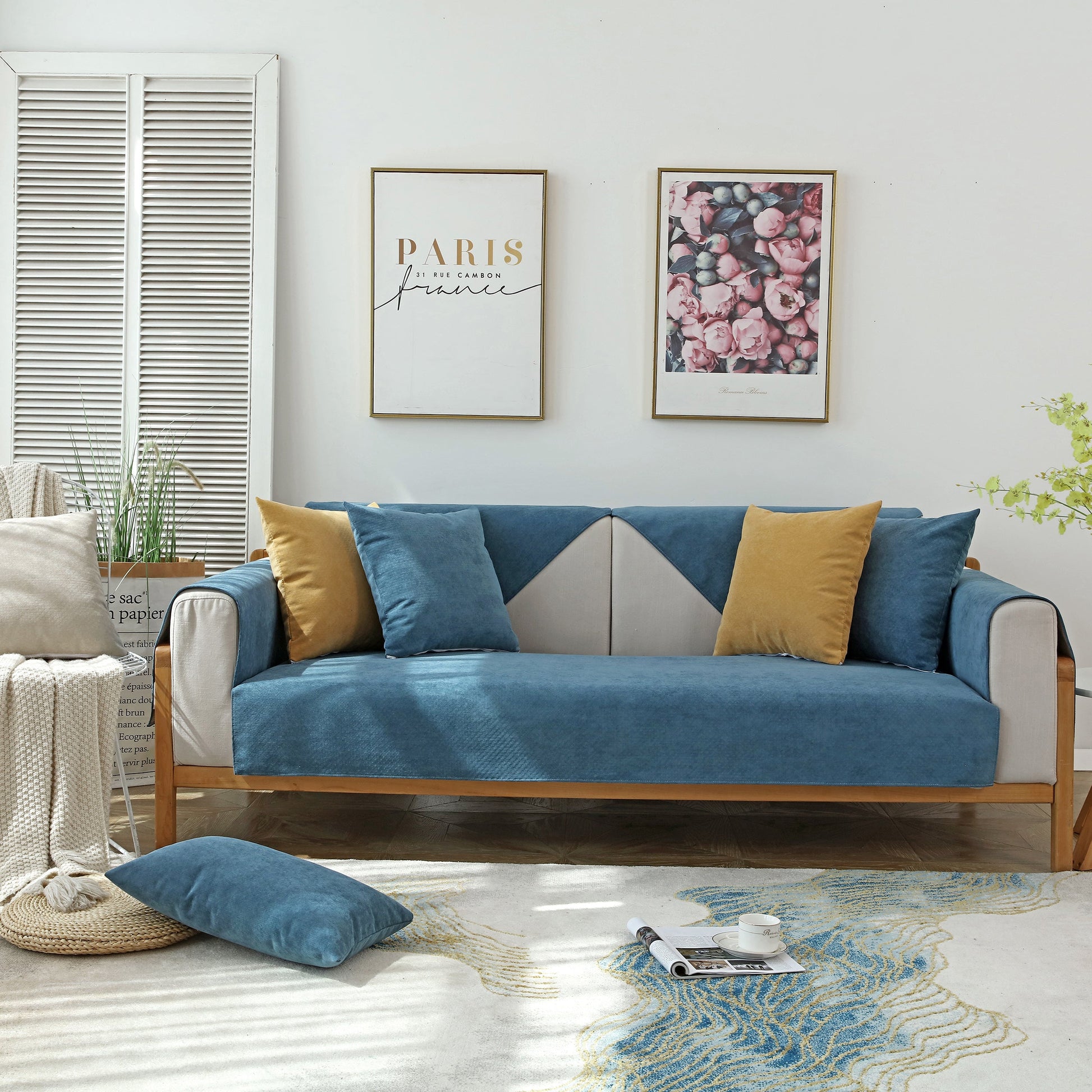 Living room with Waterproof Non-Slip Quilted Corduroy Sofa Covers for Pets, Sectional Couch Covers, blue color with pillows.