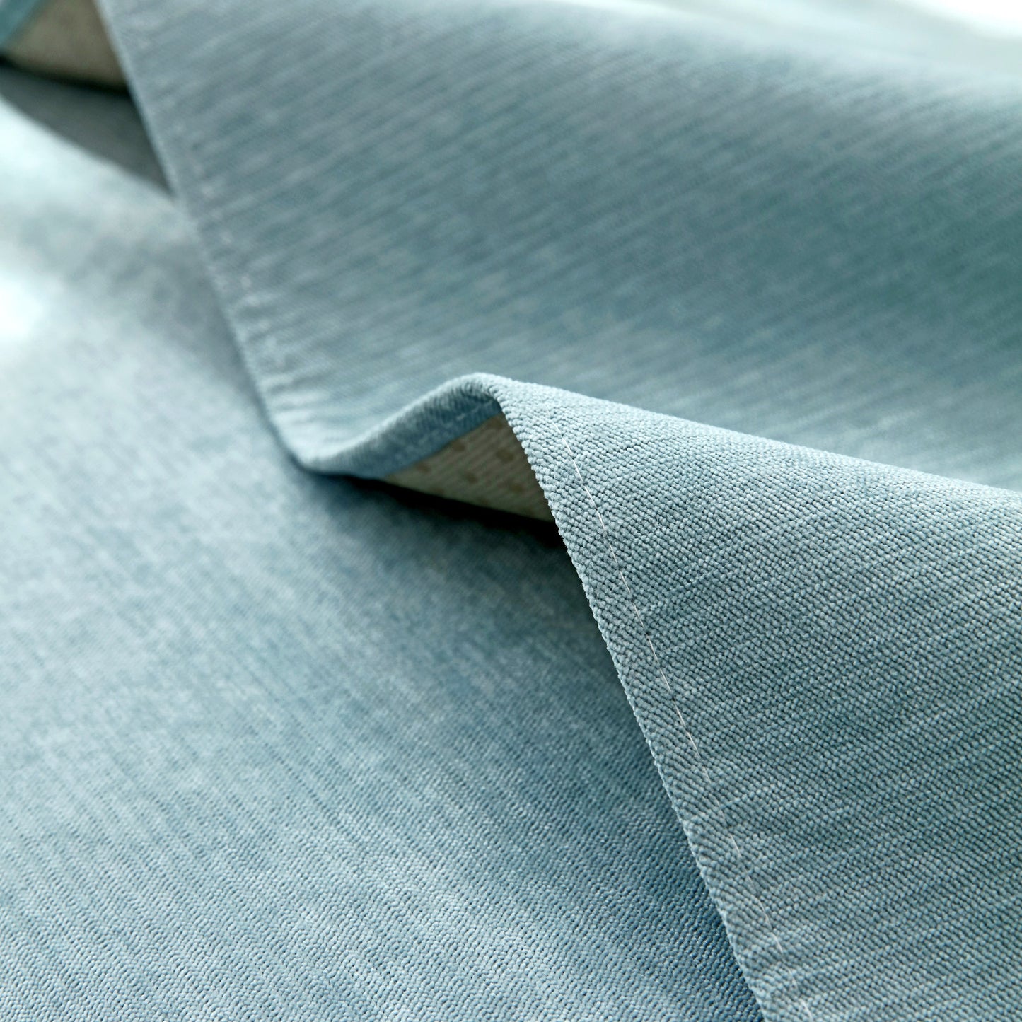 Close-up of blue quilted fabric texture from Waterproof Non-Slip Quilted Corduroy Sofa Covers for Pets, Sectional Couch Covers.
