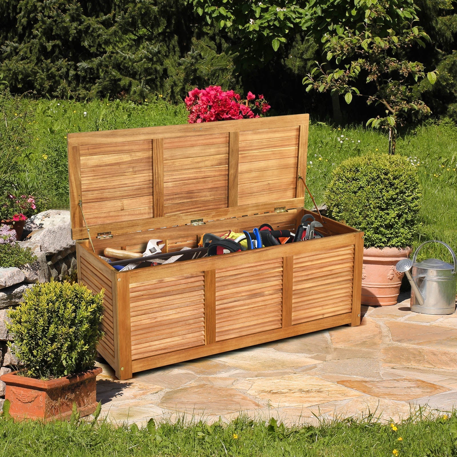 46 Gallon Acacia Wood Storage Bench Box for Patio Garden Deck with lid open showing gardening tools inside on a sunny day
