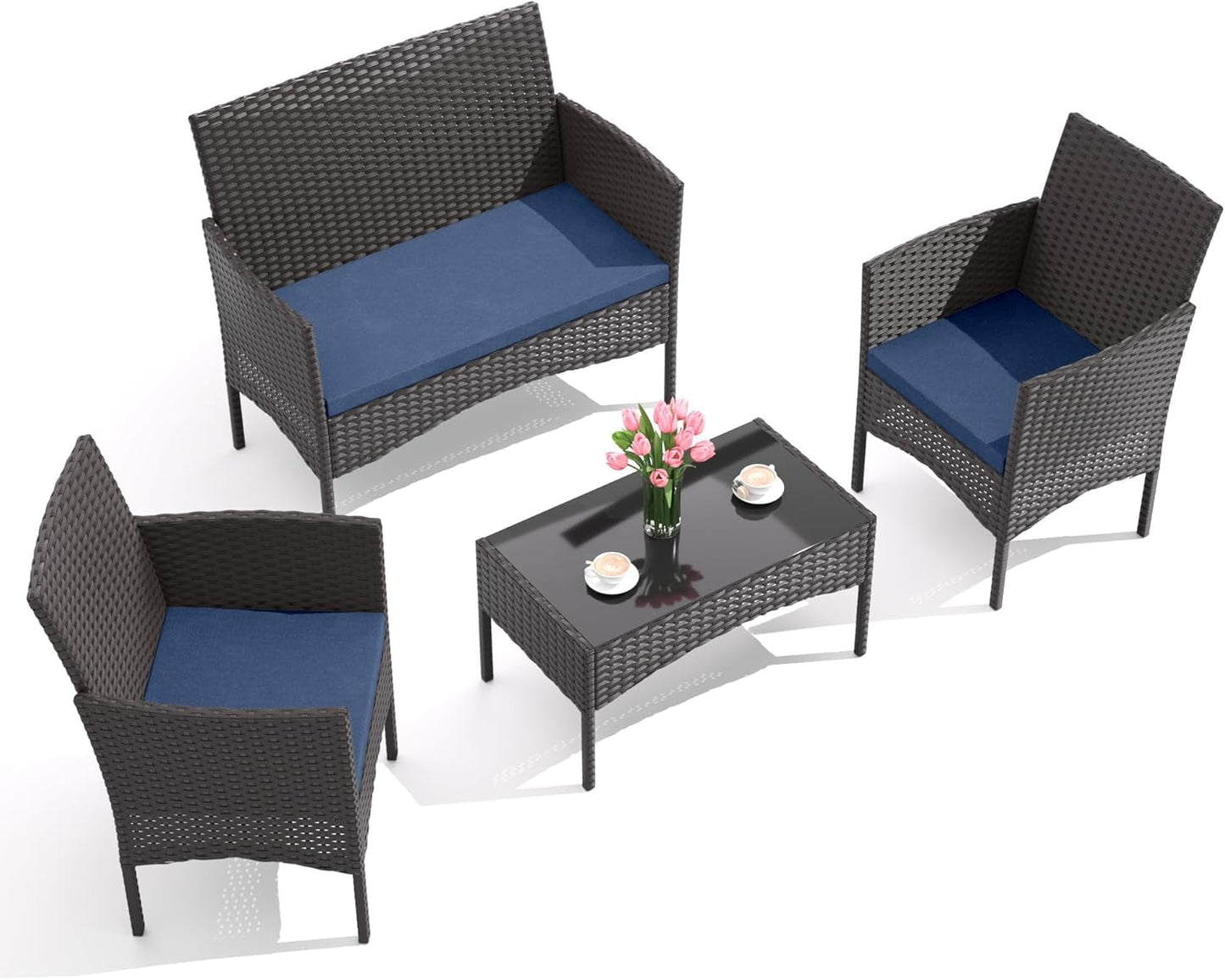 Stylish Four-Piece Outdoor Patio Furniture Set with Cushions featuring wicker chairs, cushioned sofa, and glass table with decor.