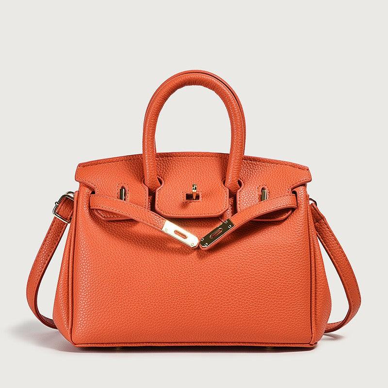 Elegant orange leather handbag with a structured design and top handle, perfect for stylish everyday use.