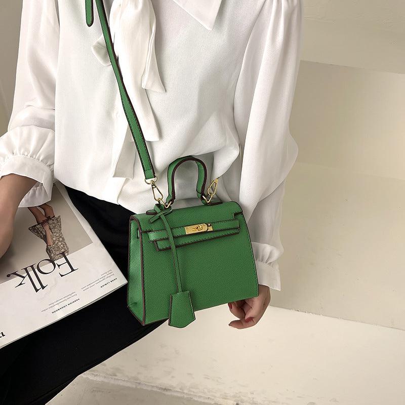 Luxury Cowgirl Kelly Purse – Trendy, High-Fashion Leather Handbag with Adjustable Strap in green on woman's lap, stylish accent