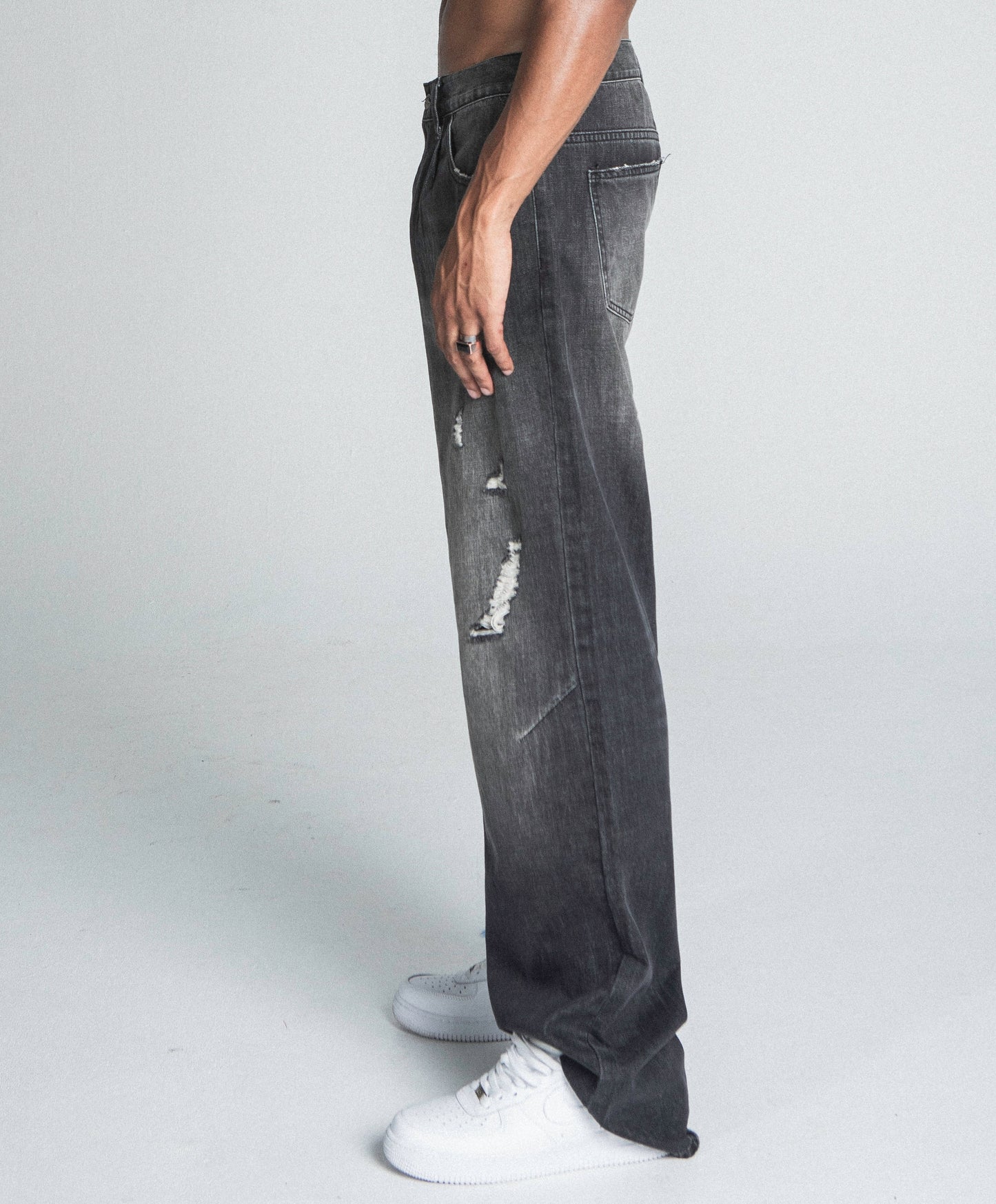 Side view of AJ09B-2 BLACK DISTRESSED BAGGY JEANS with ripped details, mid-rise fit, and five-pocket design.