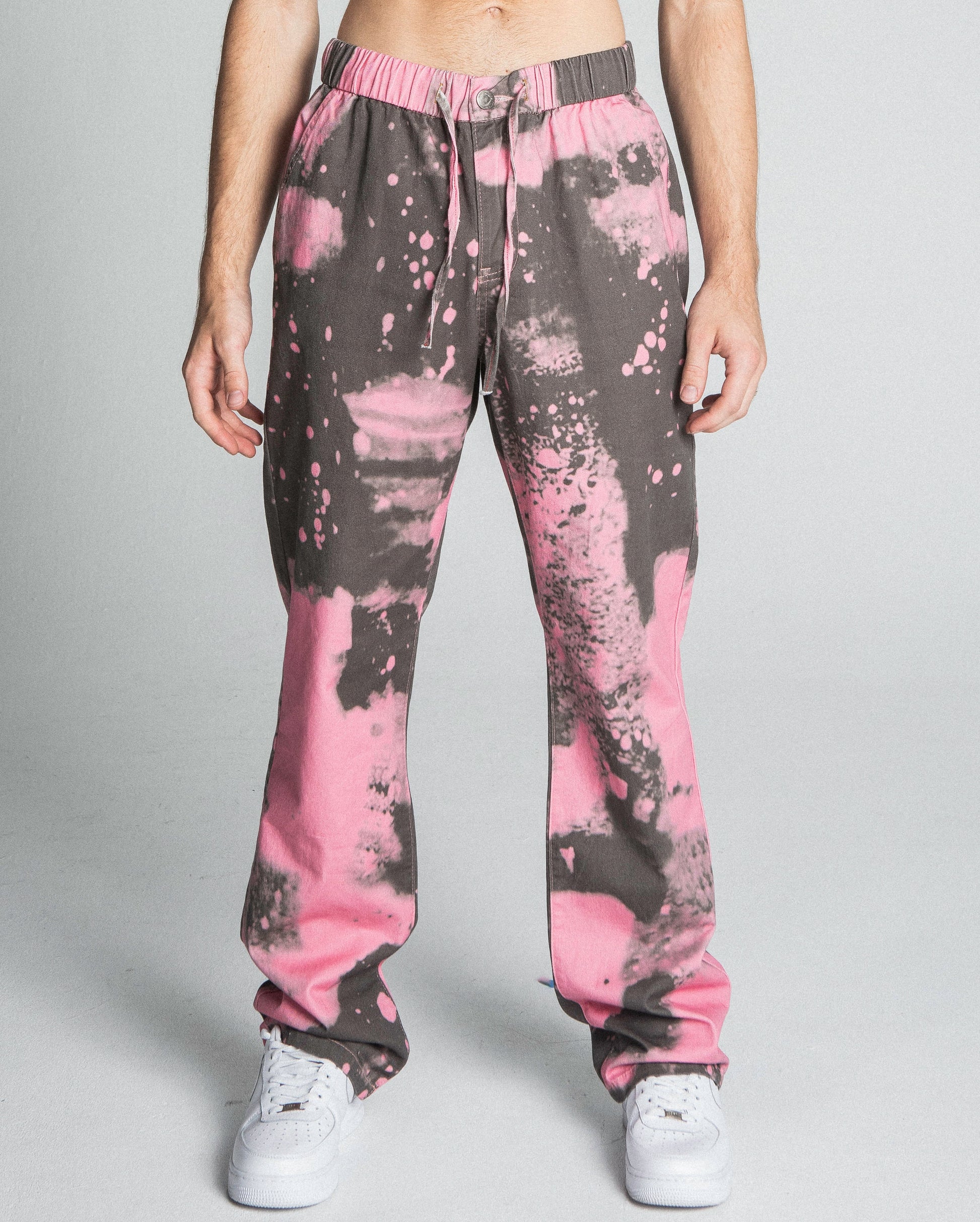 AJ04SK COLOR DYE STACKED JEANS in pink, featuring mid-rise, straight-leg design, five-pocket style, and elastic band fastening.