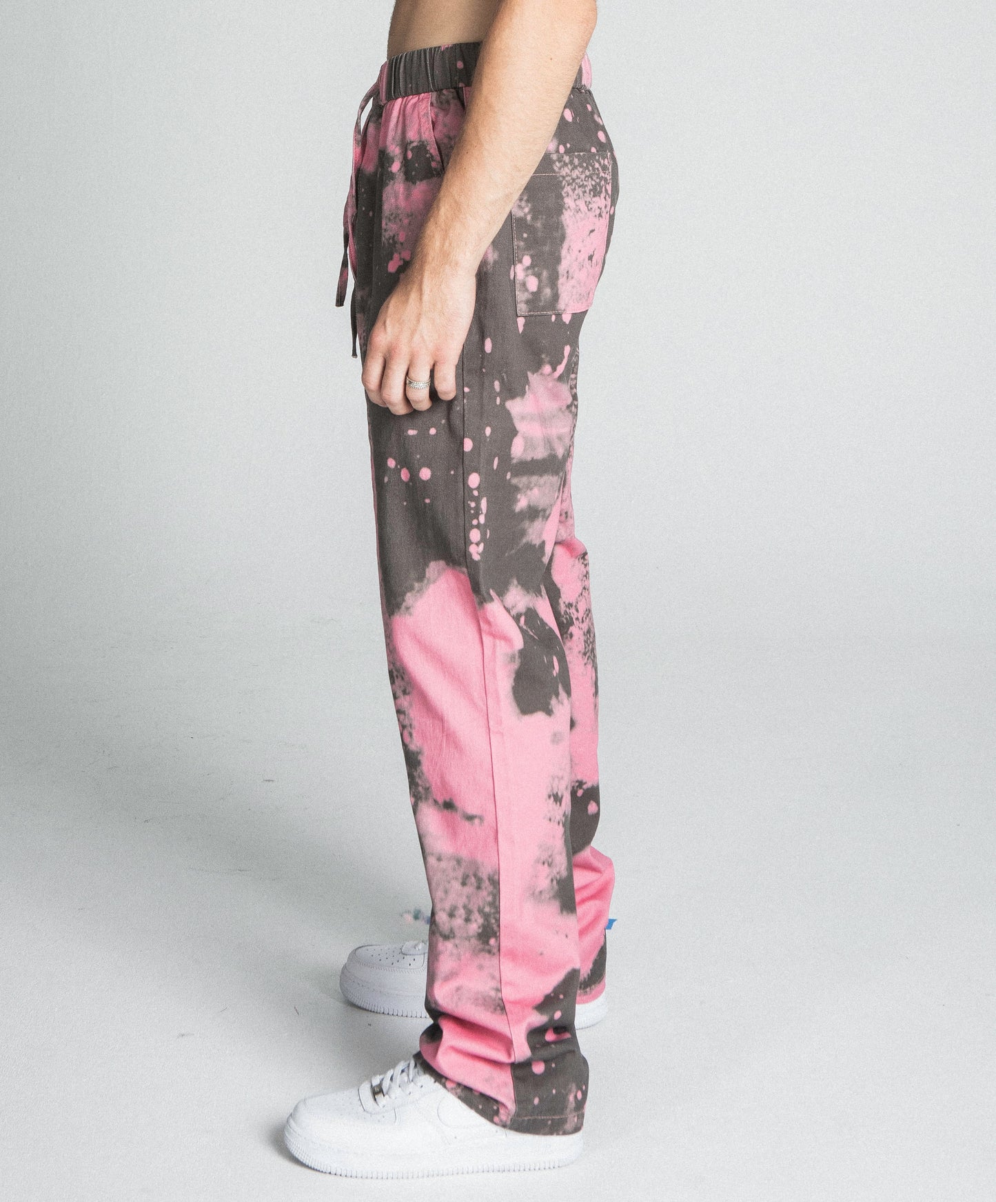 Model wearing AJ04SK COLOR DYE STACKED JEANS in pink with mid-rise waist, cotton fabric, and straight-leg design.