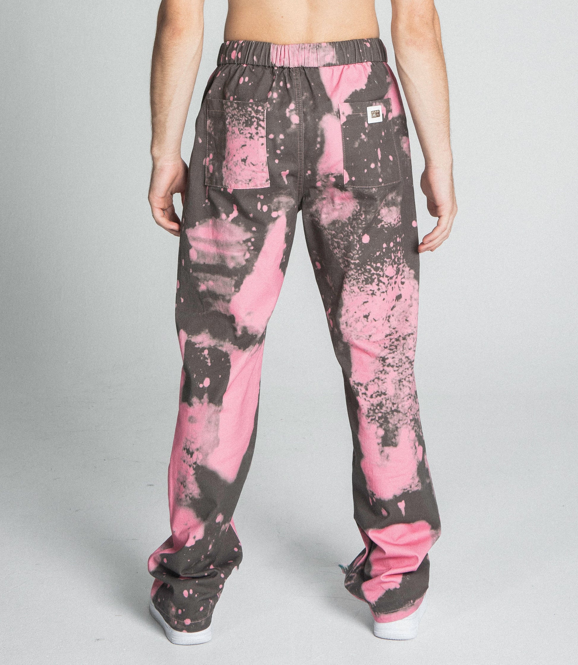 Back view of AJ04SK COLOR DYE STACKED JEANS with pink dye detail, mid-rise, straight-leg, elastic band, five-pocket design.