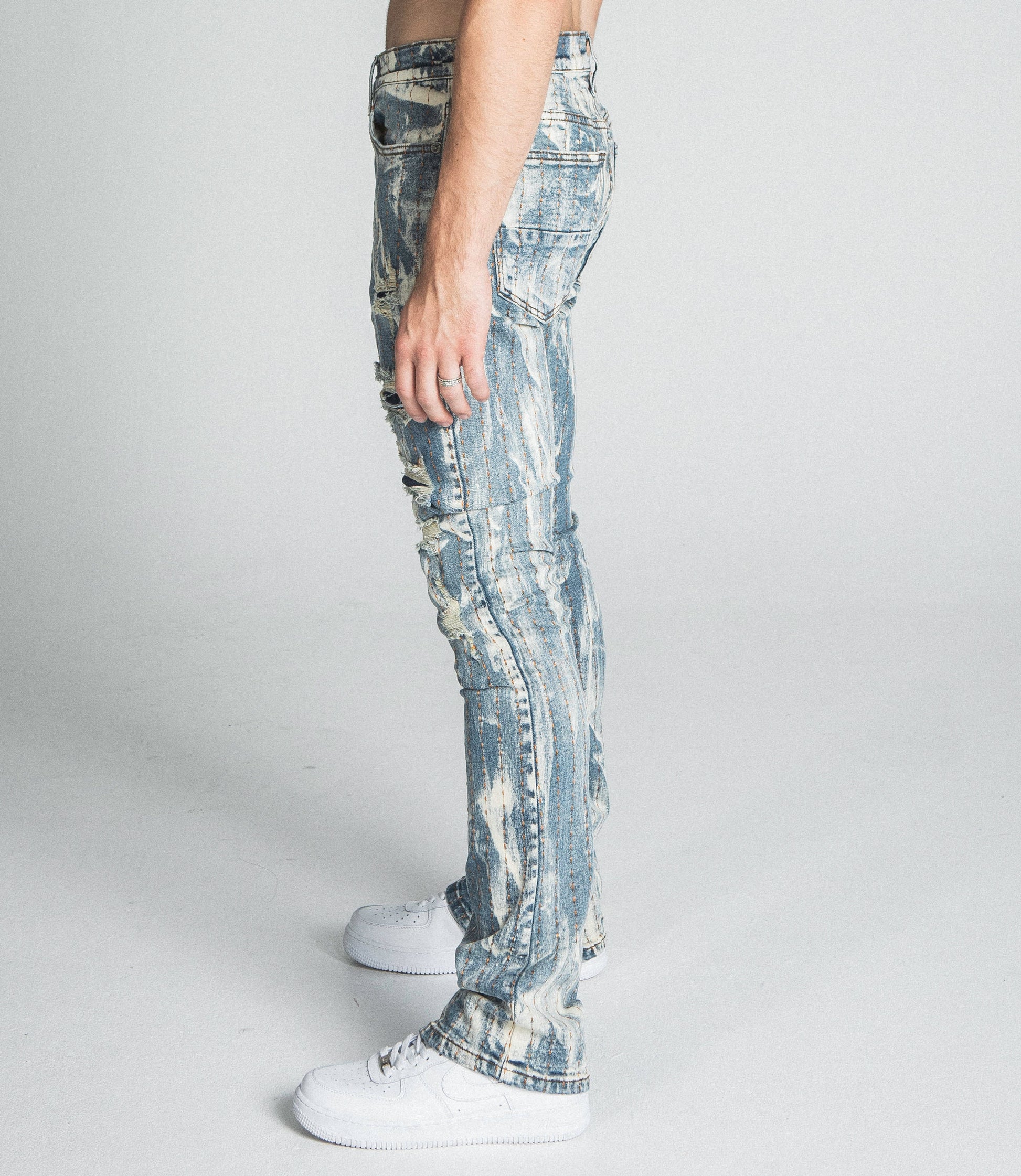 Side view of AJ17SK THREAD LINE STACKED JEANS featuring stretchy vintage wash denim, mid-rise waist, and stacked leg design.