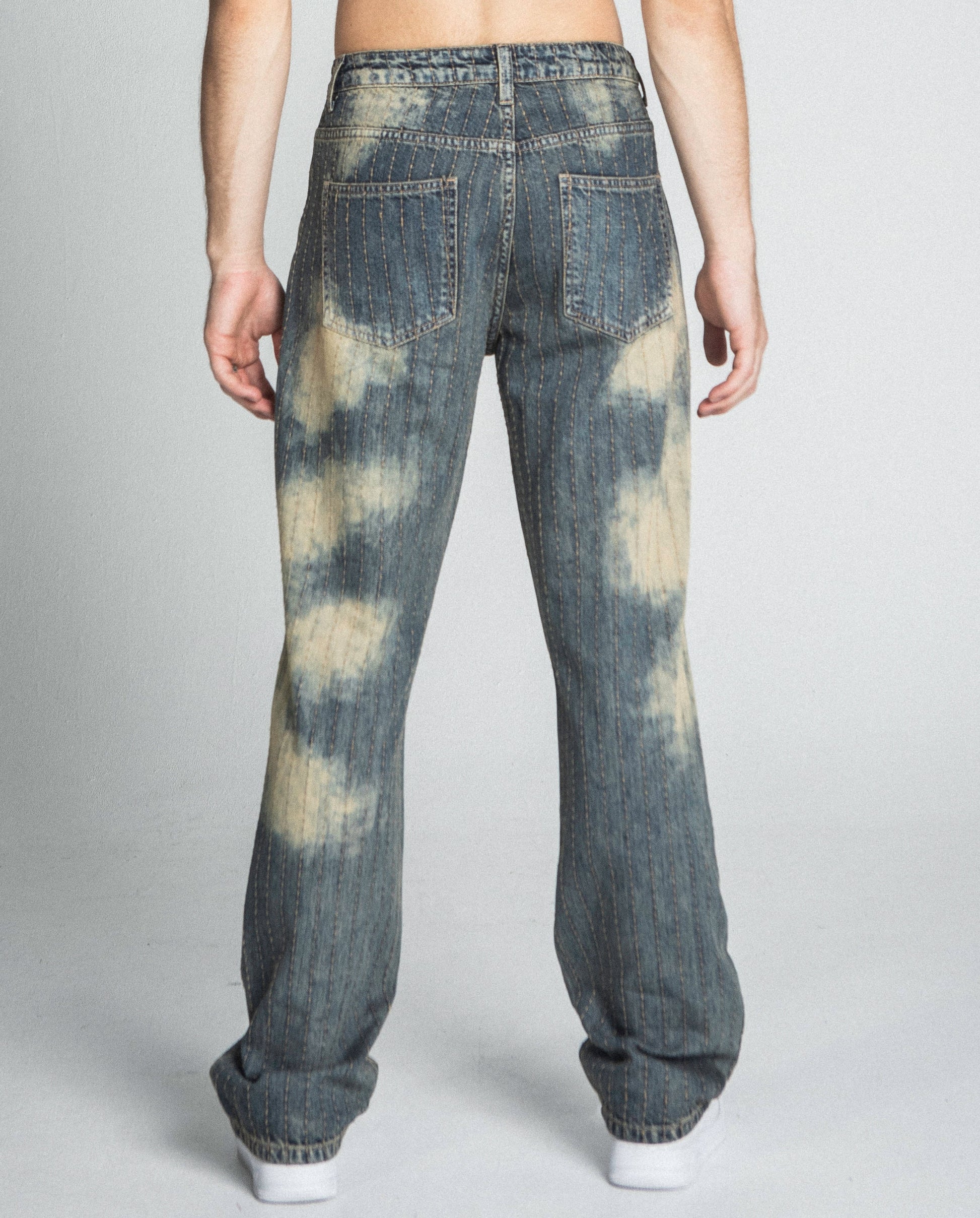Back view of AJ01L-3 VINTAGE THREAD LINE LOOSE JEANS in a straight-leg design, mid-rise waist, and unique dye pattern.
