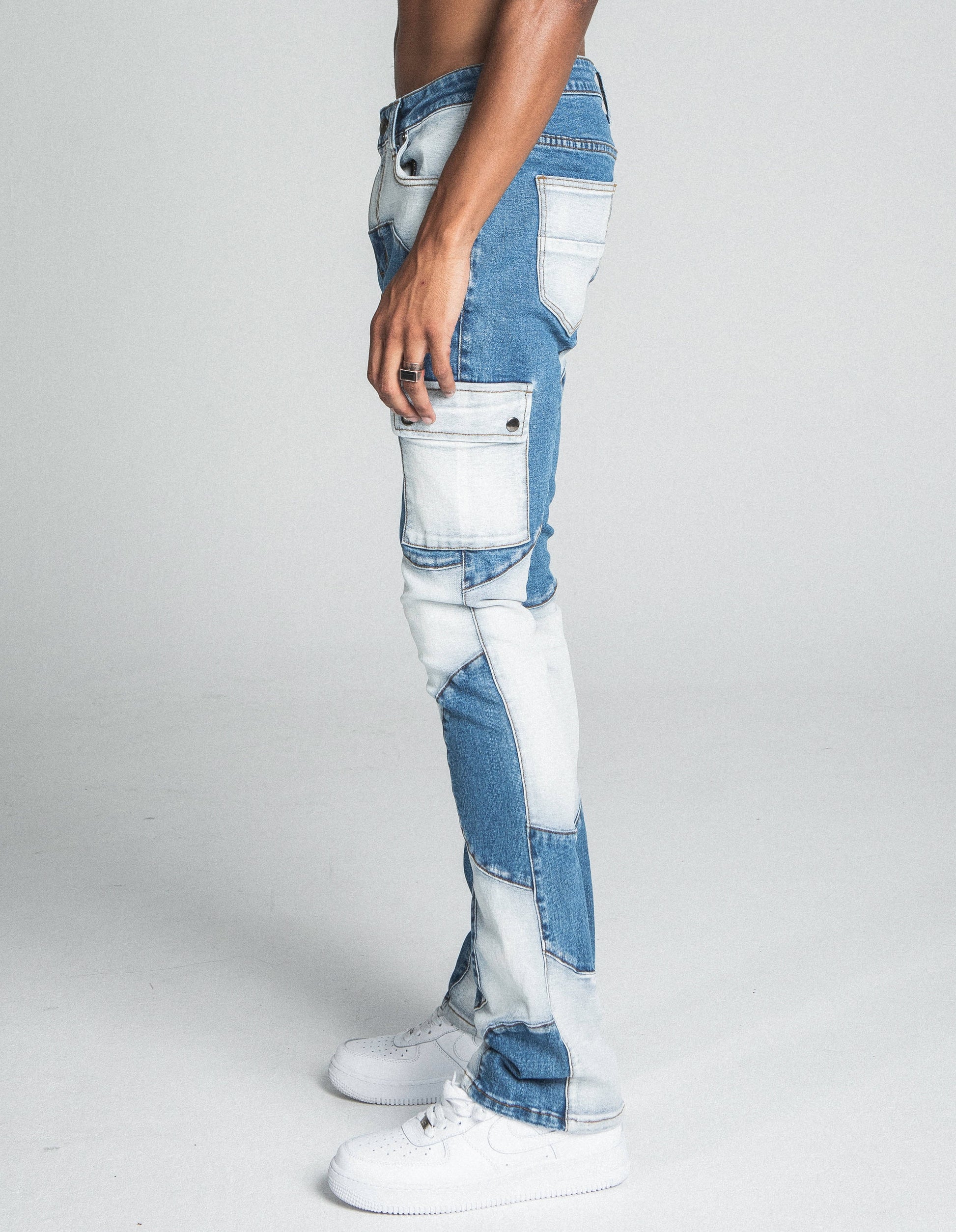 Side view of AJ40SK COLOR BLOCK STACKED JEANS featuring mid-rise waist, stretchy denim, and five-pocket design with belt loops.