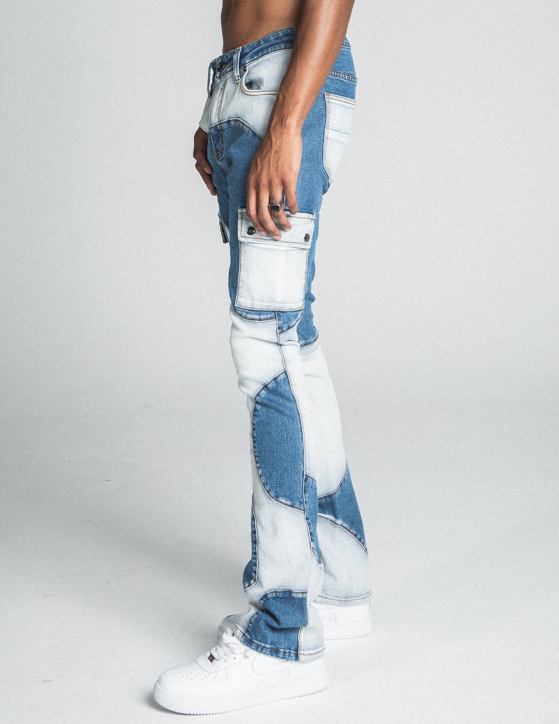 Side view of AJ40SK COLOR BLOCK STACKED JEANS showcasing stretchy mid-rise fit with patchwork and pocket details.