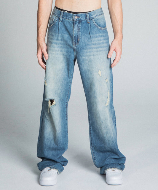 AJ09-3 CLASSIC BLUE LIGHTLY DISTRESSED BAGGY JEANS with mid-rise, loose fit, five-pocket design, and faded cotton fabric.