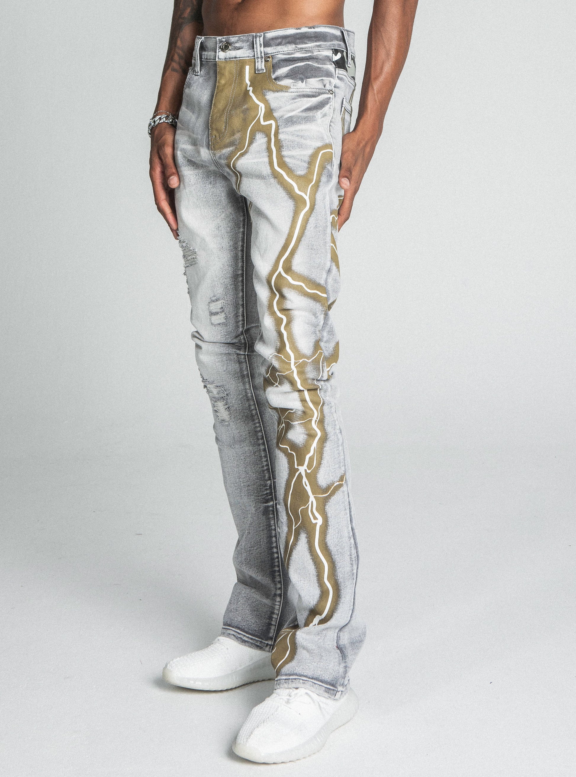 Model wearing AJ24SK LIGHTNING STACKED JEANS with lightning design, mid-rise waist, and stretchy fabric.