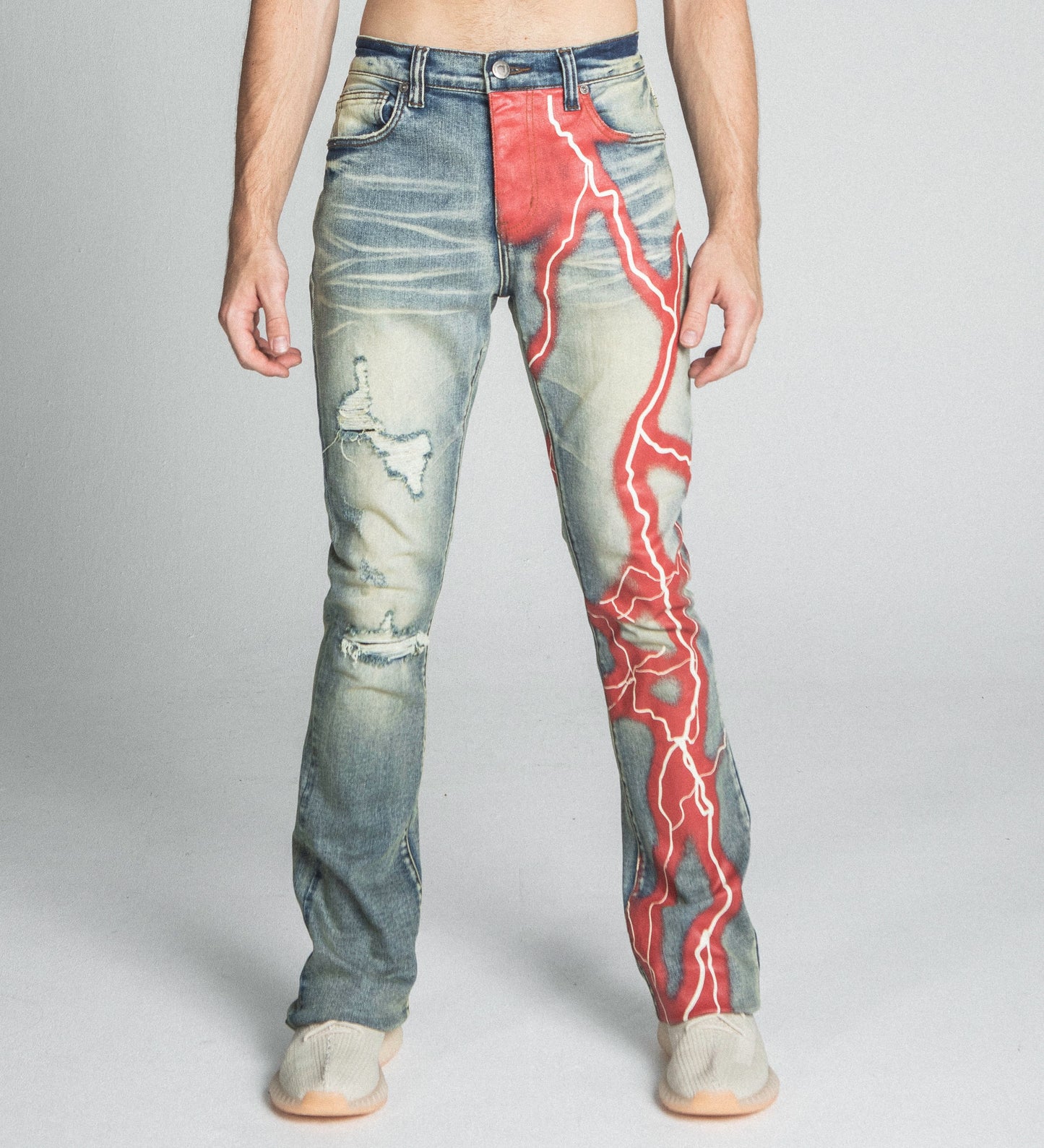 Stylish AJ24SK LIGHTNING STACKED JEANS featuring a red lightning design, mid rise, five pockets, and stretchy cotton fabric.