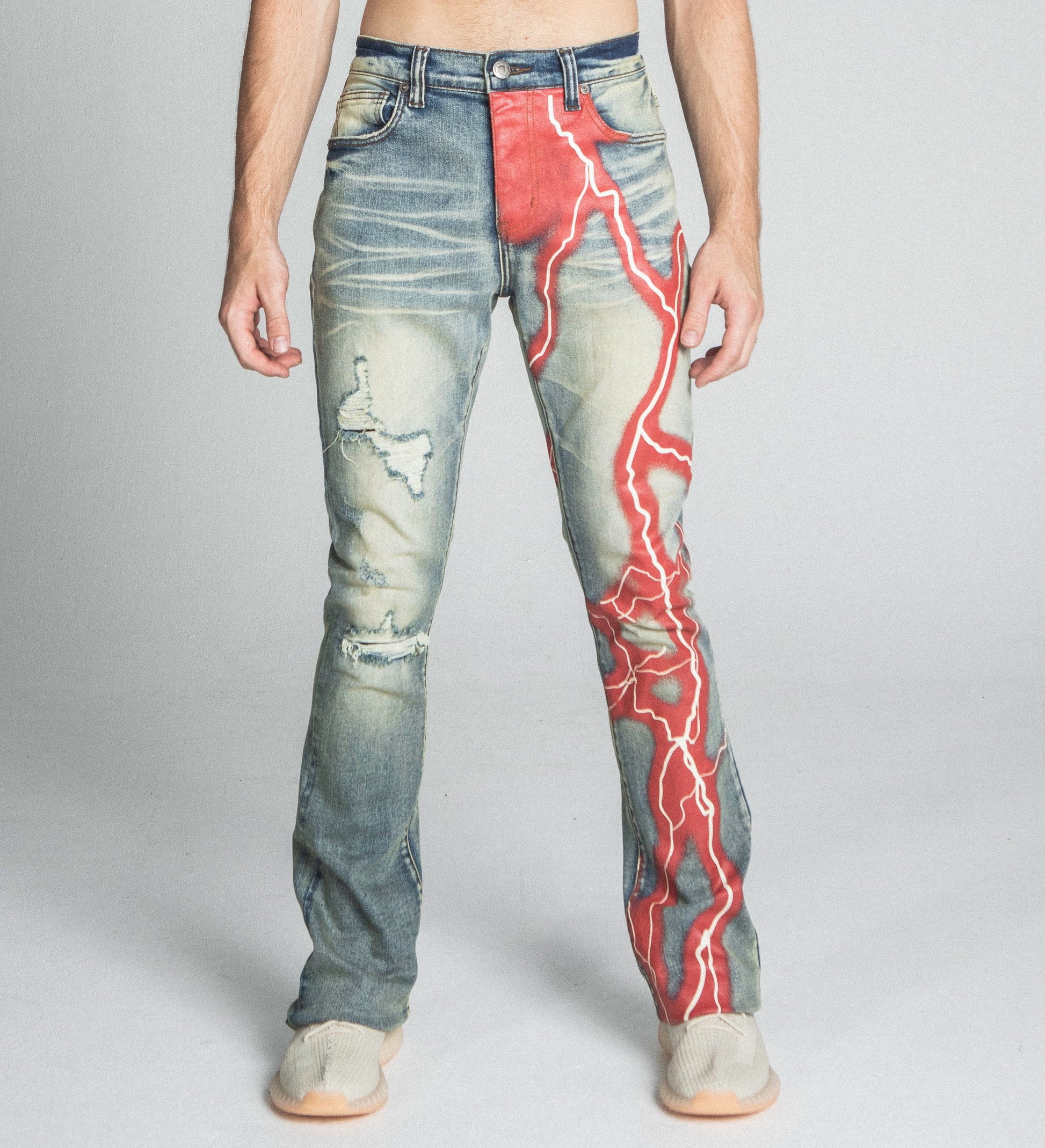 Stylish AJ24SK LIGHTNING STACKED JEANS featuring a red lightning design, mid rise, five pockets, and stretchy cotton fabric.