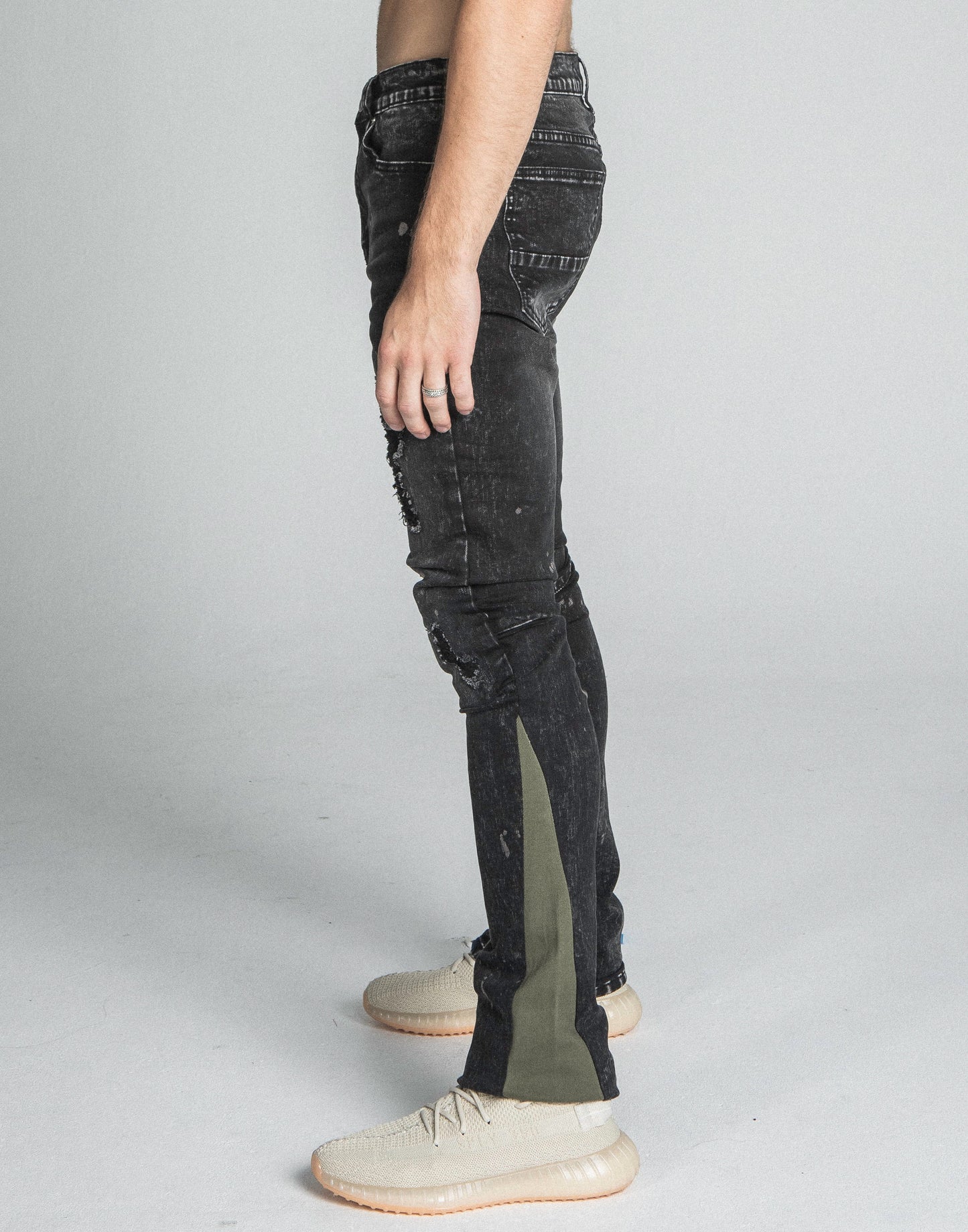Side view of AR711 BLACK/BROWM DISTRESSED STAR STACKED JEANS, showcasing mid-rise, stretchy fabric, and five-pocket design.